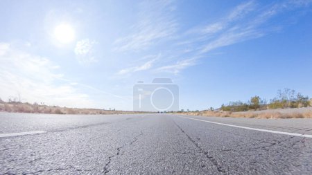 Photo for Embarking on a road trip from Nevada to California, driving on Highway 15 during the day offers scenic views and an exciting journey between states. - Royalty Free Image