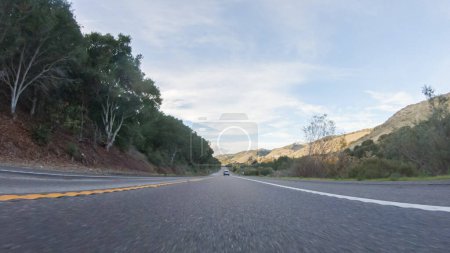 Photo for Basking in the beauty of a sunny winter day, driving on HWY 1 near Las Cruces, California offers stunning views of the picturesque coastal landscape against a backdrop of clear blue skies. - Royalty Free Image