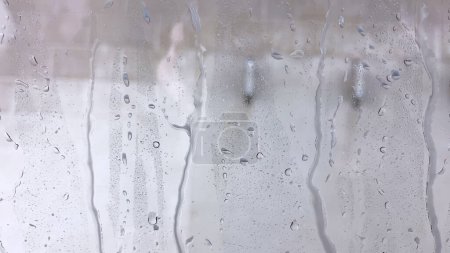 Photo for Soapy windshield view from inside a car during an automatic wash cycle, with the foam obscuring the outside. - Royalty Free Image