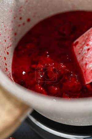 Photo for In a small saucepan, the measured ingredients come together - allowing the delicious Raspberry Cake Filling to simmer and infuse with delightful flavors. - Royalty Free Image