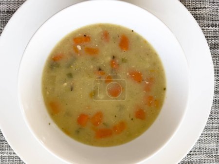 comforting bowl of chicken and rice soup, brimming with tender carrots and seasoned to perfection, promises warmth and satisfaction.