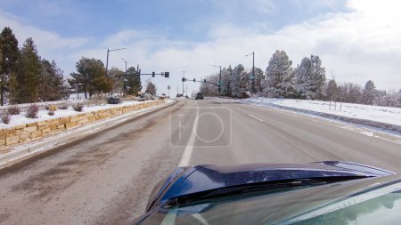 Foto de Tormenta post-invierno, la unidad en una carretera suburbana proporciona un viaje tranquilo. La pintoresca escena, con nieve adornando el paisaje, se suma a la tranquilidad de la experiencia. - Imagen libre de derechos