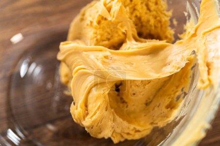 Photo for Whipping up salted caramel buttercream frosting for the gingerbread bundt cake. - Royalty Free Image