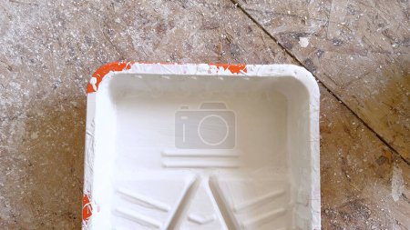 Photo for The promise of a new look begins with this paint tray, prepped and waiting to transform a space during a residential remodeling project. - Royalty Free Image