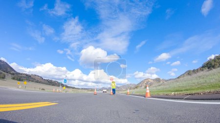 Photo for Santa Maria, California, USA-December 6, 2022-Vehicle is cruising along the Cuyama Highway under the bright sun. The surrounding landscape is illuminated by the radiant sunshine, creating a - Royalty Free Image