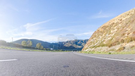 Photo for Under a clear blue sky, driving on HWY 101 near Californias El Capitan State Beach during the day offers captivating views of the scenic coastal surroundings. - Royalty Free Image