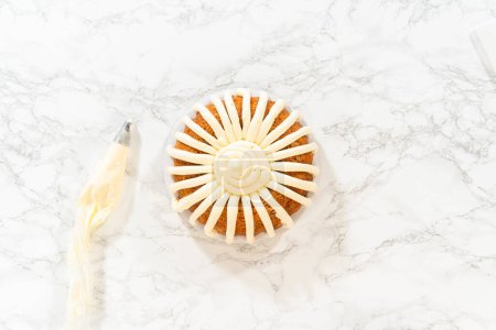Photo for The freshly baked Carrot Bundt Cake is beautifully frosted with a luscious layer of cream cheese frosting. - Royalty Free Image