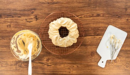 Téléchargez les photos : Pose plate. Un gâteau de bundt de pain d'épice généreusement givré avec glaçage au caramel salé et surmonté de délicieuses saupoudrées de pain d'épice. - en image libre de droit
