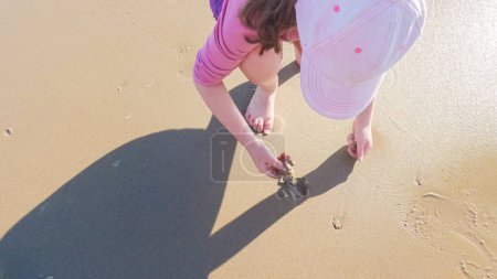 Photo for A little girl joyfully plays on the vast, empty sands of El Capitan State Beach in California during winter. - Royalty Free Image