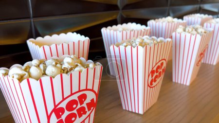 Rows of freshly filled striped popcorn boxes await eager moviegoers, their nostalgic design adding to the anticipation of entertainment.