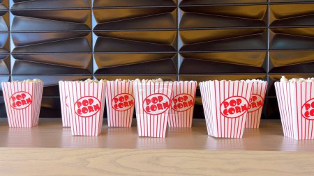 Rows of freshly filled striped popcorn boxes await eager moviegoers, their nostalgic design adding to the anticipation of entertainment.