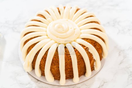 The freshly baked Carrot Bundt Cake is beautifully frosted with a luscious layer of cream cheese frosting.