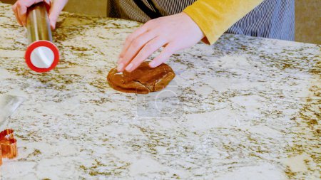 Photo for Using an adjustable rolling pin to roll out gingerbread cookie dough on the elegant marble counter in a modern kitchen, getting ready for festive holiday baking. - Royalty Free Image