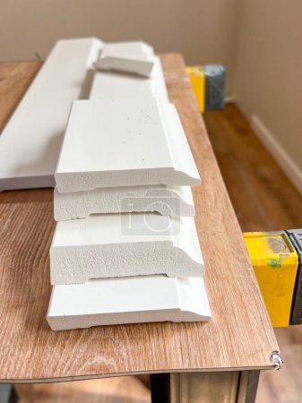Witness the professional installation of vinyl baseboards in a stylish modern home, adding a sleek finishing touch to the interior design.