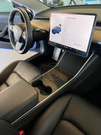 Foto de Castle Rock, Colorado, Estados Unidos-14 de marzo de 2024-El interior de un Tesla Model 3, con sus asientos negros premium y su moderno salpicadero, recibe una meticulosa limpieza en el garaje de una residencia privada. - Imagen libre de derechos