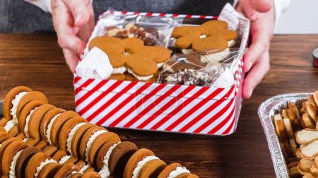 Photo for Lovingly homemade gingerbread and sugar cookies, half-dipped in rich chocolate, nestled in decorative Christmas tin boxes perfect for seasonal gifting. - Royalty Free Image