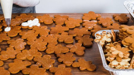 Photo for Crafting gingerbread cookie sandwiches with eggnog buttercream, presented on a rustic wooden table for Christmas gifting. - Royalty Free Image