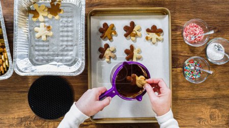 Photo for Flat lay. Creating snowflake-shaped cutout sugar cookies, dipped in chocolate, and adorned with different toppings. - Royalty Free Image