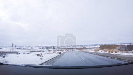 Photo for The open highway invites a peaceful drive, with snow-clad pines lining I-25 as the journey continues from Denver towards Colorado Springs on a snowy day. - Royalty Free Image