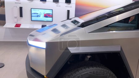 Photo for Colorado Springs, Colorado, USA-March 23, 2024-The futuristic Tesla Cybertruck takes center stage in the showroom of a Tesla store, with interested visitors and sleek car designs in the backdrop, all - Royalty Free Image