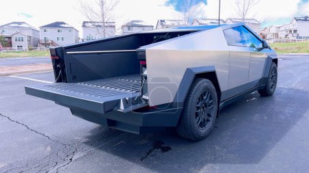 Photo for Denver, Colorado, USA-April 28, 2024- Showcasing the utility of the Tesla Cybertruck, this image features the vehicle open cargo bed, highlighting its spacious and functional design, parked in a - Royalty Free Image