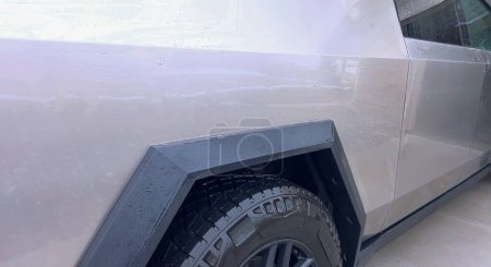 Photo for Denver, Colorado, USA-April 28, 2024- This image captures a Tesla Cybertruck undergoing a thorough cleaning, focusing on the high-pressure washing of its cargo bed, demonstrating the maintenance of - Royalty Free Image
