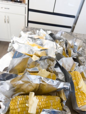 Photo for This image showcases fresh corn on the cob, neatly arranged in vacuum-sealed plastic packaging to preserve its freshness and flavor, ready for distribution or sale. - Royalty Free Image