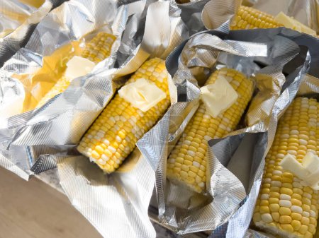 Photo for This image showcases fresh corn on the cob, neatly arranged in vacuum-sealed plastic packaging to preserve its freshness and flavor, ready for distribution or sale. - Royalty Free Image