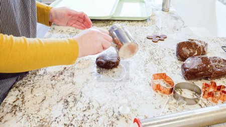Photo for Using an adjustable rolling pin to roll out gingerbread cookie dough on the elegant marble counter in a modern kitchen, getting ready for festive holiday baking. - Royalty Free Image