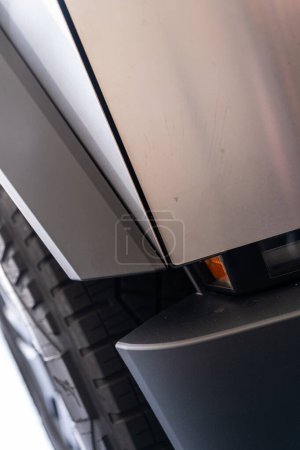 Photo for Denver, Colorado, USA-May 5, 2024-This image showcases the seamless design and sturdy architecture of the Tesla Cybertruck, featuring a detailed view of the side panel and tire, emphasizing the - Royalty Free Image