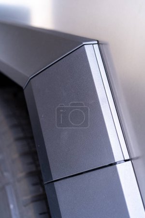 Photo for Denver, Colorado, USA-May 5, 2024-This image captures a close-up view of the Tesla Cybertruck, highlighting the intricate design and angular lines of its exterior. The focus on the edge of the panel - Royalty Free Image