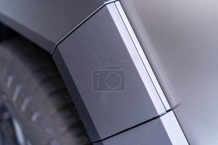 Photo for Denver, Colorado, USA-May 5, 2024-This image captures a close-up view of the Tesla Cybertruck, highlighting the intricate design and angular lines of its exterior. The focus on the edge of the panel - Royalty Free Image