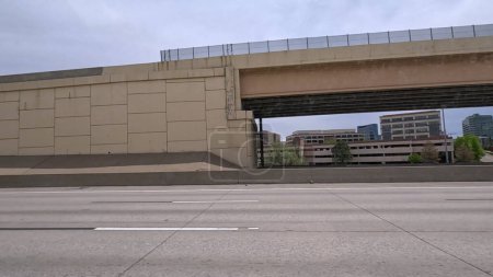 Ein dynamischer Blick auf die erhöhte Autobahnüberführung in South Denver, der die komplexen Betonstrukturen und das moderne Straßendesign zeigt. Das Bild fängt die ausgedehnten Gassen und die umliegende Landschaft ein