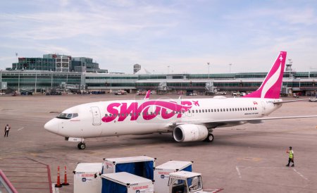 Photo for Montreal, Quebec, Canada - 07 04 2022 : Boeing 737-800 jet airliner of Swoop airline parked in the airport of Montreal. Swoop is a Canadian ultra low-cost airline owned by WestJet Airlines Ltd., the - Royalty Free Image