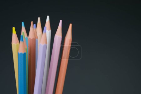 A variety of colored pencils are neatly arranged in a cup, showcasing different shades and colors.