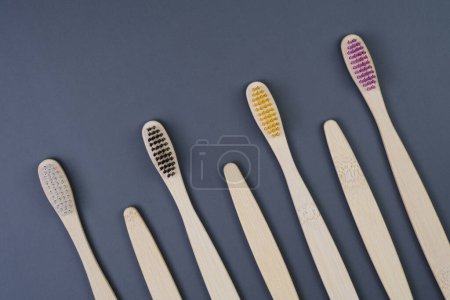 Fünf Zahnbürsten sind perfekt in einer sauberen Reihe angeordnet, wobei jede eine andere Farbe und ein anderes Design aufweist..