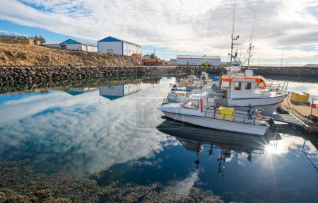 Photo for Group of small fishing boat parking at the Stodvarfjordur harbour a neat small town in East fjord of Iceland. - Royalty Free Image