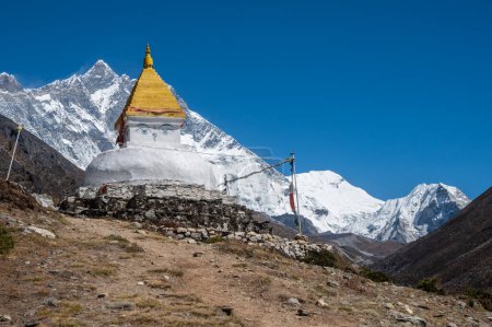 An ancient Tibetan Buddhist stupa with beautiful view of Himalayas in the background seen from Dingboche village in rural Nepal.