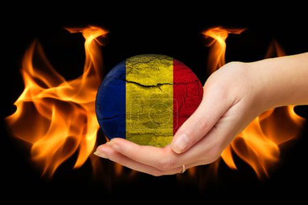 Téléchargez les photos : Romania Earthquake. Mournful banner. The Epicenter of the earthquake. Pray for Romania. A bright stone rock background of Romania flag. Disaster war. Planet Earth with fire in hand. Support. - en image libre de droit