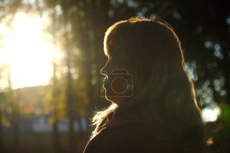 woman gazes into the horizon, embodying themes of mental well-being, optimism, and contentment. Blurred. Out of focus.