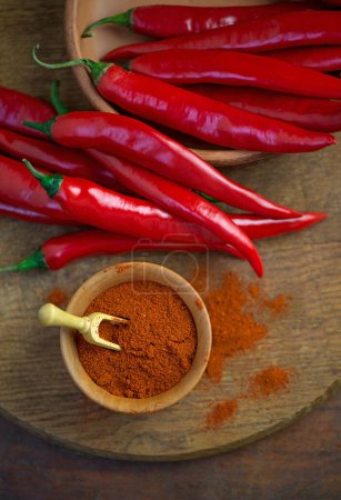fresh red chili peppers on wooden board - chili background