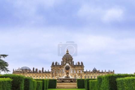 Photo for Castle Howard, North Yorkshire, UK - September 3, 2021: Facade of Castle Howard with Atlas Fountain as viewed from parterre gardens south of the palace. - Royalty Free Image
