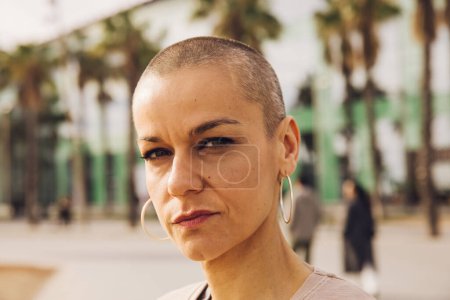 serious bald woman outdoor portrait. High quality photo