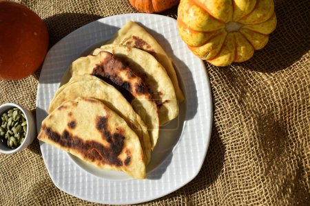 Photo for Pumpkin Quesadilla and pumpkins on burlap background, top view - Royalty Free Image
