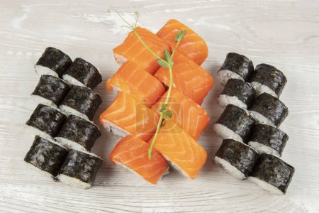 Zestaw różnych bułek sushi na białym drewnianym tle zbliżenie.