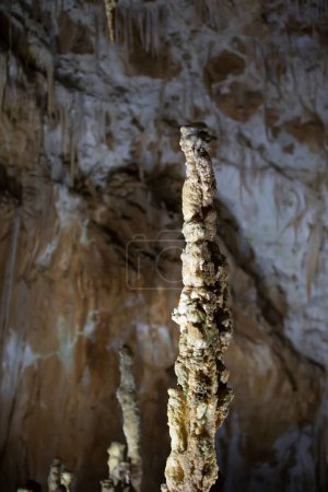 The cave is karst, amazing view of stalactites and stalagnites illuminated by bright light, a beautiful natural attraction in a tourist place.