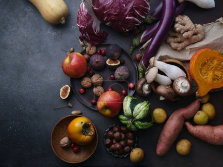 Photo for Top view seasonal groceries, healthy vegetarian ingredients for cooking a dinner on a dark background - Royalty Free Image