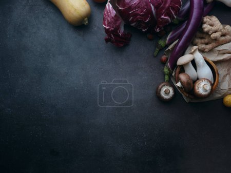 Téléchargez les photos : Top view seasonal groceries, healthy vegetarian ingredients for cooking a dinner on a dark background - en image libre de droit