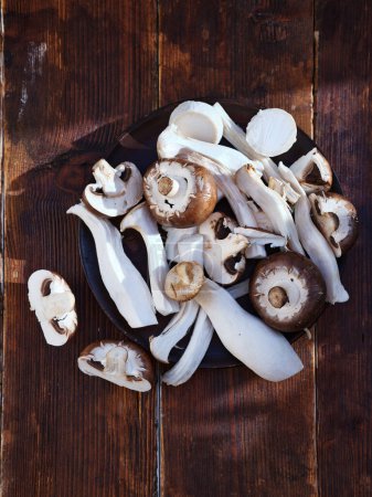 Photo for Top view various mushrooms cut on a plate - Royalty Free Image