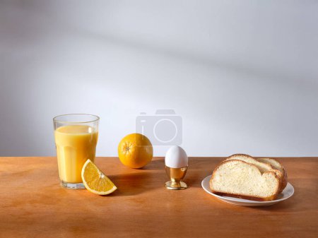 Photo for Breakfast with a glass of fresh-pressed orange juice and some slices of brioche bread - Royalty Free Image